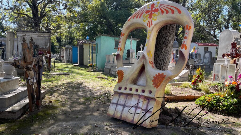 Escultura de calavera gigante entre tumbas en el Panteón Municipal de Puebla